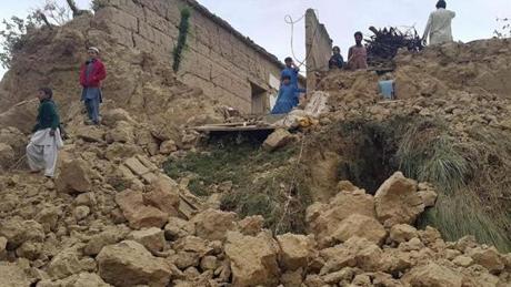 Local residents surveyed collapsed houses in Bajaur tribal region near the Afghan border in Pakistan on Monday.
