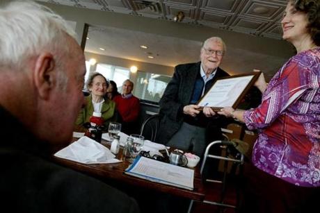 Kimberly Buttrick of the National Weather Service in Taunton presented awards to Robert Lautzenheiser, standing, and Robert Skilling, left, during a celebration at the at the Red Parrot Restaurant Hull on Wednesday. Lautzenheiser was joined by his wife Dorothy, seated. 
