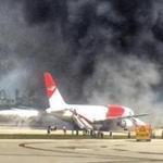 Passengers evacuated from a plane on fire at Fort Lauderdale airport.