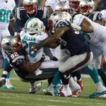Patriots rookie defensive lineman Geneo Grissom (92) wrapped up Dolphins running back Lamar Miller in the third quarter. 