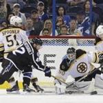 Boston Bruins goalie Jonas Gustavsson (50), of Sweden, makes a save on a shot by Tampa Bay Lightning center Jonathan Marchessault (42) as Bruins Ryan Spooner (51) and Kevan Miller (86) defend during the first period of an NHL hockey game Saturday, Oct. 31, 2015, in Tampa, Fla. (AP Photo/Chris O'Meara) 