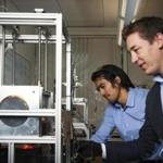 Northeastern professor Randall Erb (right) and graduate student Joshua Martin work with a 3-D printer in Erb?s lab. 