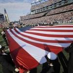 Members of the US Navy joined other members of the military displaying flags on the field of Gillette Stadium before a game between the Patriots and the Lions last November.