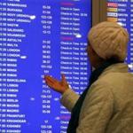 A woman gestured while standing near an information board at Domodedovo airport outside Moscow, Russia.
