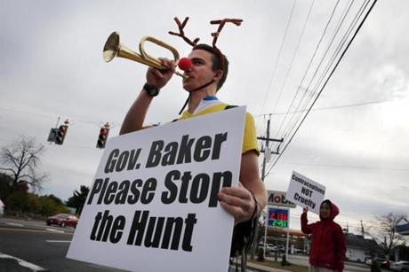 Mason Grainger, of Boston, played his bugle during a protest on Washington Street in Canton.

