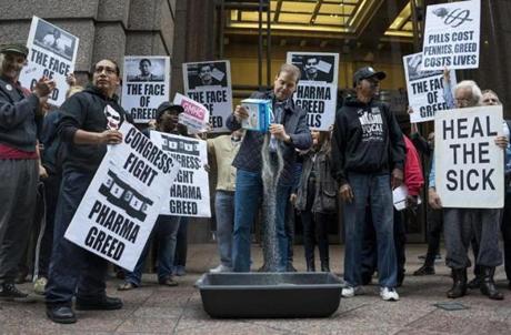 An activist protesting drug prices poured cat litter on an image of Turing Pharmaceuticals chief executive Martin Shkreli during an Oct. 1 rally outside the New York building that houses Turing?s offices.
