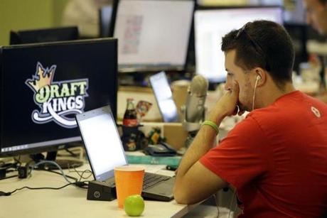 FILE - In this Sept. 9, 2015, file photo, Devlin D'Zmura, a tending news manager at DraftKings, a daily fantasy sports company, works on his laptop at the company's offices in Boston. Nevada has already decided daily fantasy sports are gambling and that people can't put their dollars down on DraftKings and FanDuel until those sites obtain a license in the state. (AP Photo/Stephan Savoia, File)
