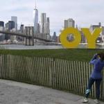 A runner paused to snap a photo of a sculpture by artist Deborah Kass in Brooklyn Bridge Park.