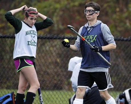 11/11/15: Manchester, MA: Robert Carter (right) is pictured during a practice session with the Manchester-Essex girl's field hockey team. (Globe Staff Photo/Jim Davis) section:sports topic:Watertown field hockey (1)

