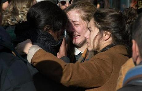 People hugged and grieved on the streets of Paris on Sunday.
