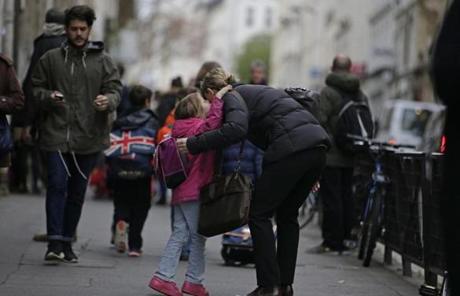 A child offered a kiss on Monday after being dropped off at a school in Paris.

