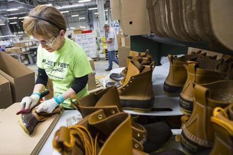 Alex Forest inspected and shined boots before packaging them at the factory in Brunswick, Maine.
