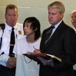Soi Ket Dang (center) is arraigned in Plymouth District Court.