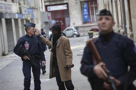 A man spoke with police near the scene of a raid on an apartment building that was aimed at finding Abdelhamid Abaaoud in the northern Paris suburb of St.-Denis on Thursday.
