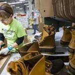 Alex Forest inspected and shined boots before packaging them at the factory in Brunswick, Maine.