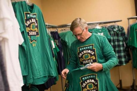 Notre Dame fan Kevin Heniff tries on a Boston-themed Notre Dame shirt as he shops in a Notre Dame pop-up store at the Marriott Hotel in Boston on Nov. 19.
