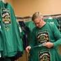 Notre Dame fan Kevin Heniff tries on a Boston-themed Notre Dame shirt as he shops in a Notre Dame pop-up store at the Marriott Hotel in Boston on Nov. 19.