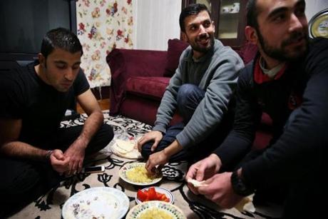 Syrian refugees Mohammad Al Asmi (left), Mahmoud Al Nayef, and Obaida Al Shamali at home in Worcester.

