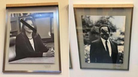 Harvard police are investigating after students at the law school discovered someone put strips of black tape over images of black professors.

