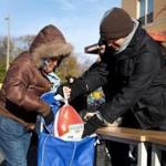 Catholic Charities of Boston and the United Way distributed Thanksgiving meal baskets to families in need in 2014.