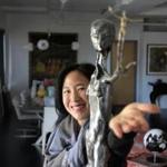 Joanne Chang-Myers with the sculpture she purchased for her husband, Christopher Myers.