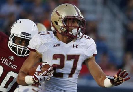 Boston College defensive back Justin Simmons (27) carries the ball after intercepting a pass intended for Massachusetts wide receiver Jalen Williams (80) during the fourth quarter of an NCAA college football game in Foxborough, Mass., Saturday, Aug. 30, 2014. Boston College won 30-7. (AP Photo/Michael Dwyer)
