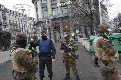 Belgian soldiers and a police officer patroled in central Brussels on Saturday.
