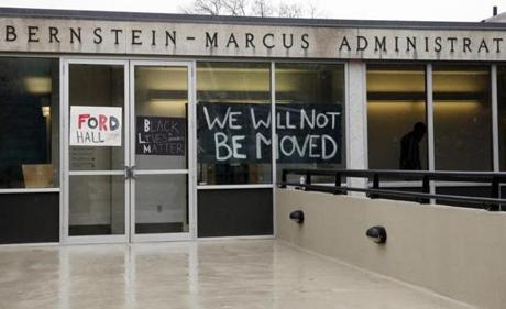 Signs were hung in the windows of the Bernstein-Marcus Administrative Building as a group of students occupied the hallway that leads to the interim president?s office at Brandeis University.
