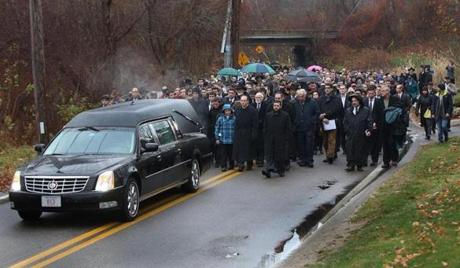 More than 1,000 mourners followed the hearse to Sharon Memorial Park on Sunday after the funeral for Ezra Schwartz.
