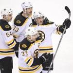 Nov 23, 2015; Toronto, Ontario, CAN; Boston Bruins left wing Brad Marchand (63) is congratulated on his short-handed goal by defenseman Zdeno Chara (33), defenseman Adam McQuaid (54) and center Patrice Bergeron (37) against the Toronto Maple Leafs at Air Canada Centre. Mandatory Credit: Tom Szczerbowski-USA TODAY Sports