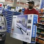A shopper carried a Samsung television at a Best Buy store in Westbury, New York, on Black Friday.