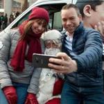 Agnes Gunnarsdottir and Bjorn Bjornsson, both visiting Boston from their native Iceland, stopped to snap a photo with Globe Santa at Faneuil Hall Marketplace last week.