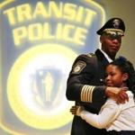 Boston, Massachusetts -- 12/02/2015- MBTA Police Chief Kenneth Green embraces his daughter, Krystin, 7, after she helped to pin his badge at his swearing in ceremony at Roxbury Community College in Boston, Massachusetts December 2, 2015. Jessica Rinaldi/Globe Staff Topic: 03MBTA Reporter: 