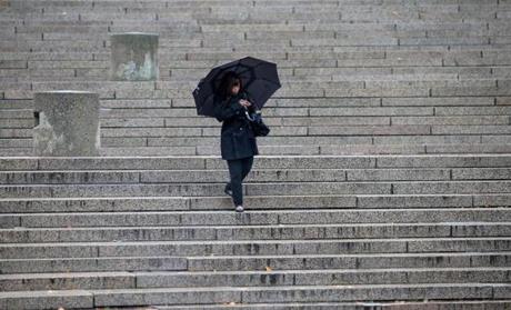 A pedestrian made her way down the City Hall Plaza steps on a dreary November day.
