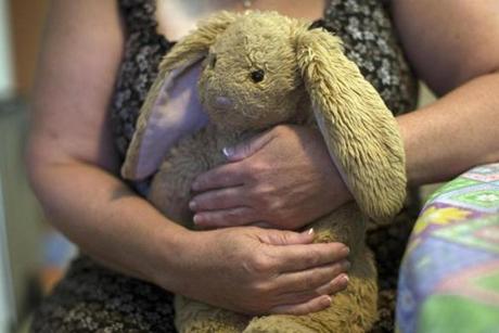 The mother of an 18-year-old who died of a suspected heroin overdose hugged a stuffed rabbit during an interview.
