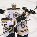 Brad Marchand (63) celebrated his first-period goal with Patrice Bergeron (center) and Joe Morrow.