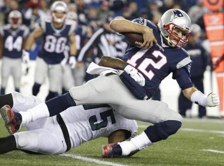 Patriots Tom Brady gets tackled by Eagles Vinny Curry in the third quarter Sunday, Dec. 6, 2015 at Gillette Stadium. (Matthew J. Lee/Globe Staff)
