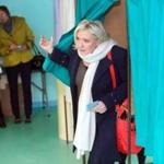 French Far-Right National Front President Marine Le Pen exited from a polling booth before voting for the first round of regional elections. 