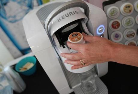 Burlington, MA., 09/23/15, One of the pods goes into the new machine. This is a sneak peak at the Keurig Kold, the company's first cold brewing system. Suzanne Kreiter/Globe staff
