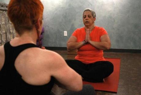 Myrna Gomez-Soto participates in a yoga session for women in breast cancer treatment at Stil Studio in Dedham. 
