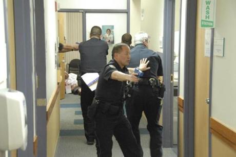 Captions: Cambridge Police and Cambridge Hospital employees at a Cambridge Health Alliance active shooter training drill at Cambridge Hospital. Credit: Tom Leslie
