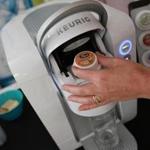 A flavor pod is placed in the Keurig Kold, the company's new cold brewing system. 