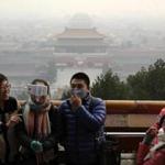 Visitors to Beijing?s Jingshan Park, some wearing masks to protect themselves from pollutants, took a selfie as smog shrouded the Chinese capital on Monday. 
