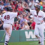 BOSTON, MA - JULY 5: Hanley Ramirez #13 of the Boston Red Sox celebrates with teammates Pablo Sandoval #48 and David Ortiz #34 after hitting a two-run home run during the seventh inning against the Houston Astros at Fenway Park on July 5, 2015 in Boston, Massachusetts. (Photo by Rich Gagnon/Getty Images)