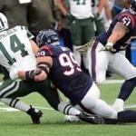 New York Jets quarterback Ryan Fitzpatrick (14) is pulled down by Houston Texans defensive end J.J. Watt (99) during the first half of an NFL football game, Sunday, Nov. 22, 2015, in Houston. (AP Photo/George Bridges)