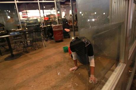 Workers cleaned the closed Chipotle Restaurant in Cleveland Circle this week.
