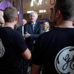 General Electric Co. CEO Jeffrey R. Immelt, center, spoke with workers as he visited a General Electric plant in Belfort, France in June 2014. 