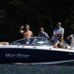 French President Nicolas Sarkozy waved to his security detail as he left for a boat ride while vacationing on Lake Winnipesaukee in Wolfeboro, N.H., in August 2007. 