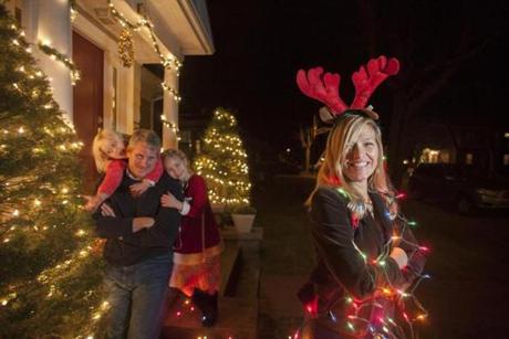 Heather and Stephen Walker with their two daughters Samantha, 6, (right) and Taylor, 4, at their Marblehead home. She's the 