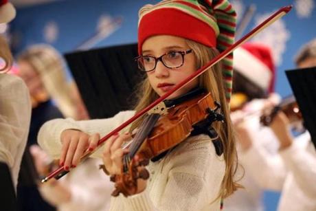 Sophie Fellows played violin during a holiday concert at the Boston Children's Hospital in Boston. 

